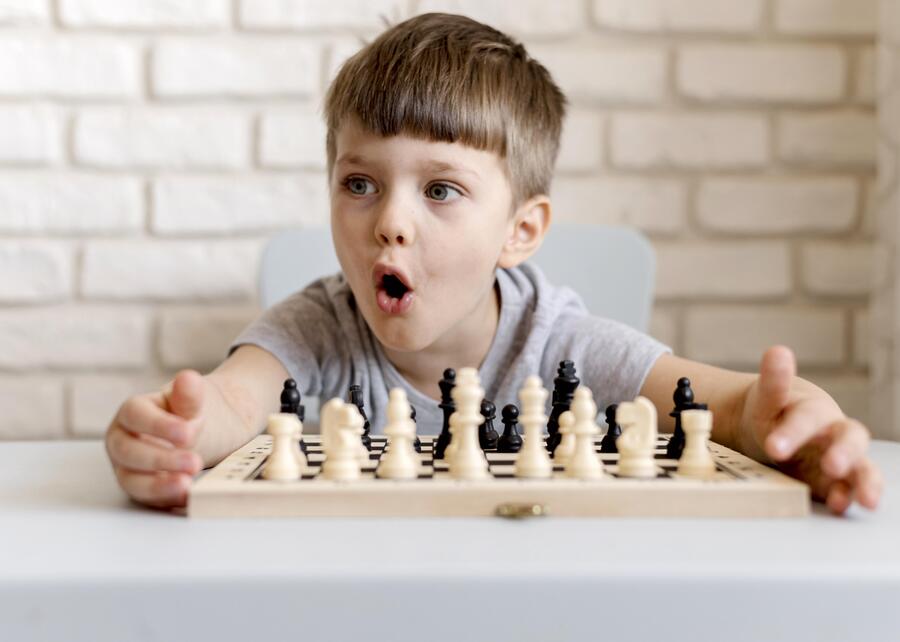 medium shot boy playing chess 1